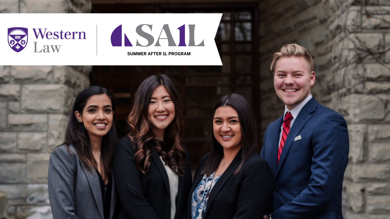 Students in business attire stand in front of Western Law